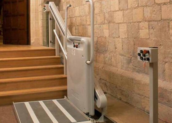 a gartec platform stair lift in a castle hallway