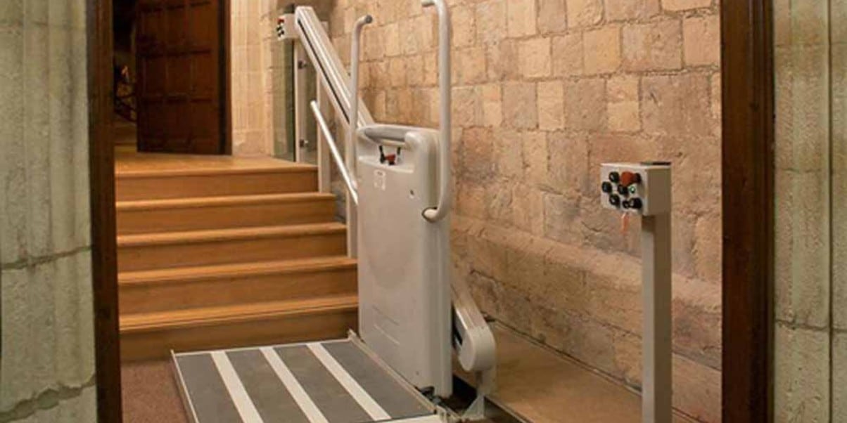 a gartec platform stair lift in a castle hallway