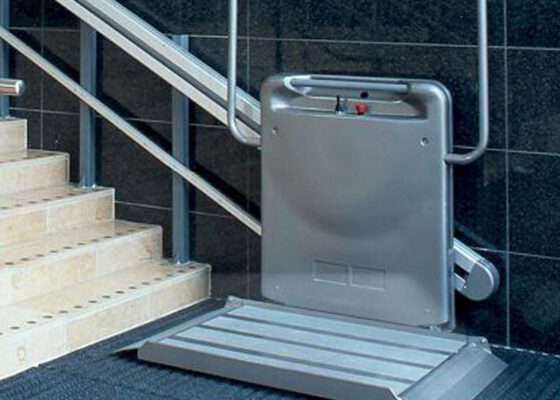 a gartec platform stair lift at the foot of a flight of stairs