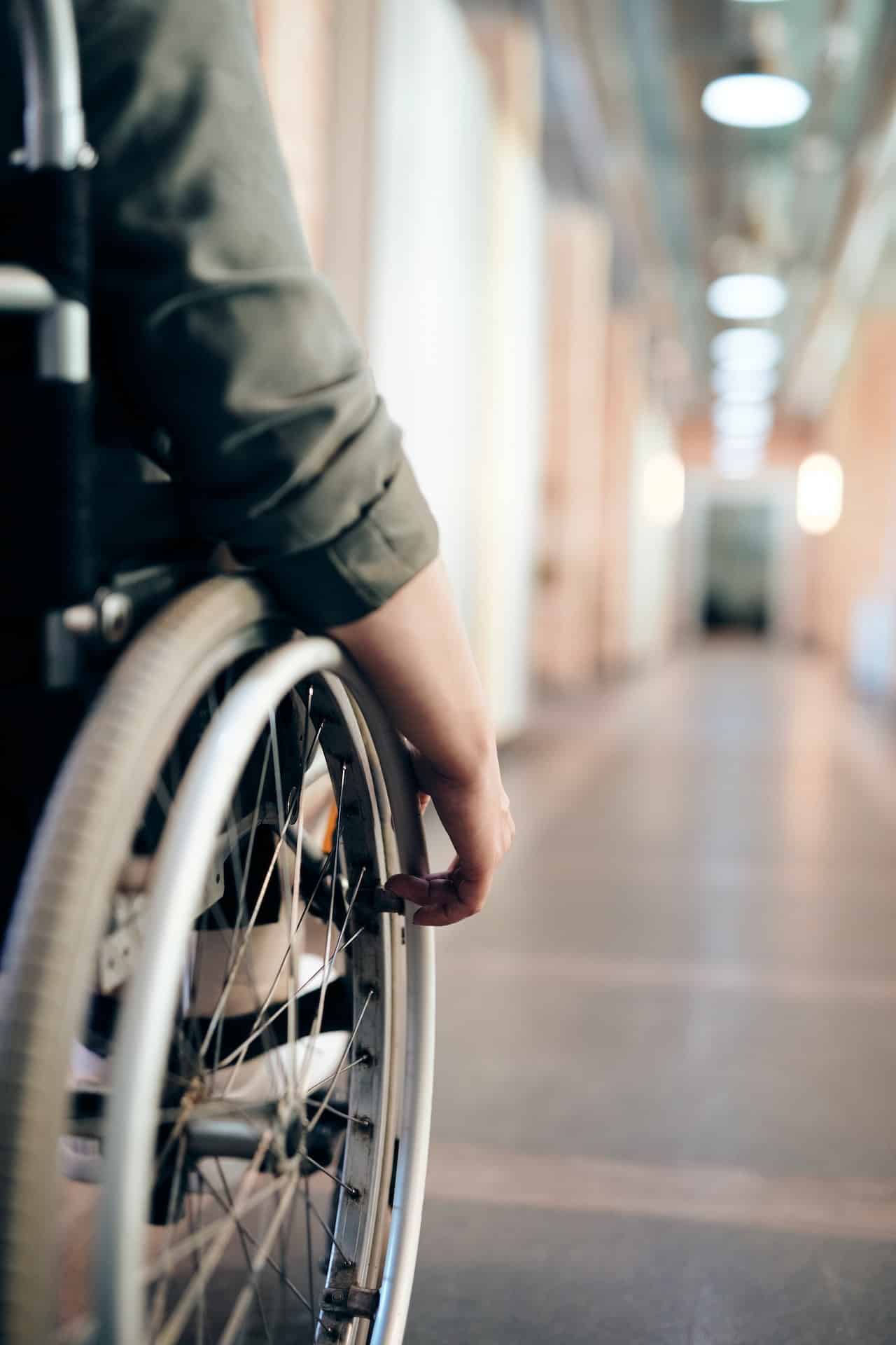 image of a person in a wheelchair in an office hallway