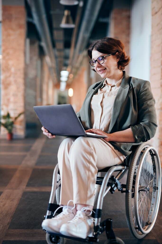 Woman in a wheelchair working on a laptop