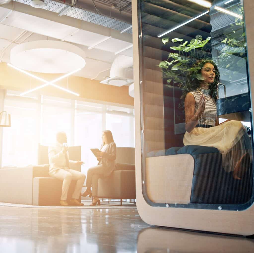 Lobby, meeting and business people in office in morning with cubicle for collaboration, teamwork and discussion. Professional, corporate and men and women walking in workspace pods for productivity