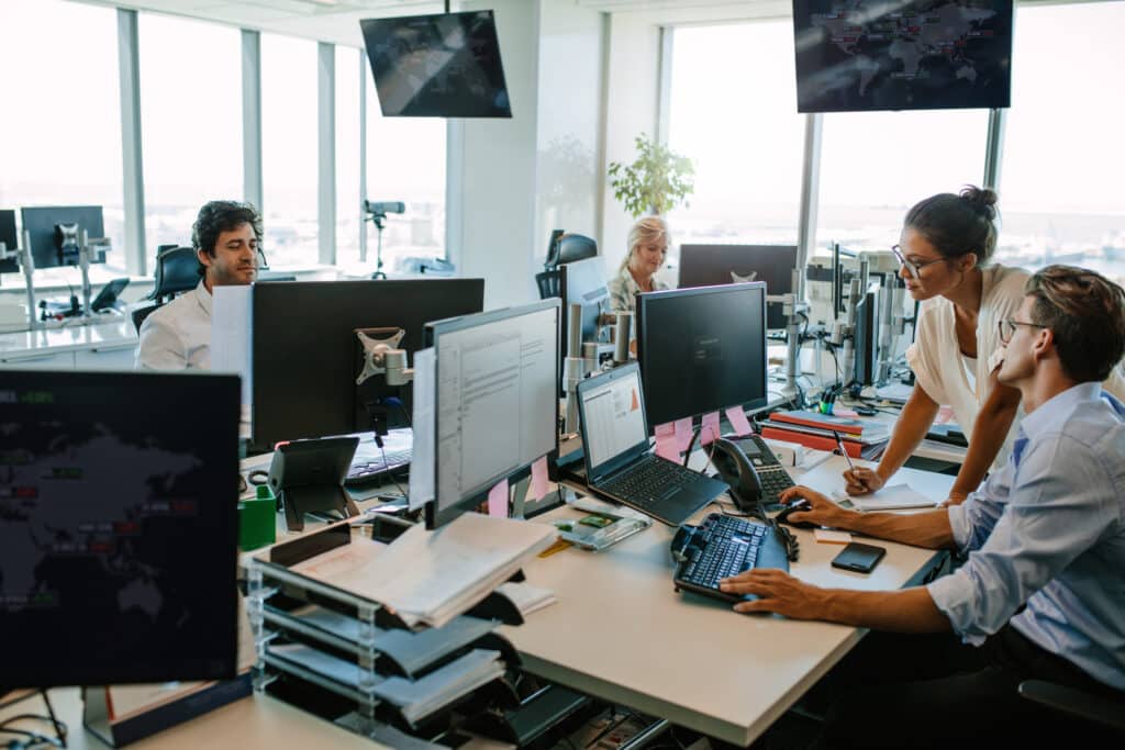 Business people working in modern office. Team working at desks in busy office.