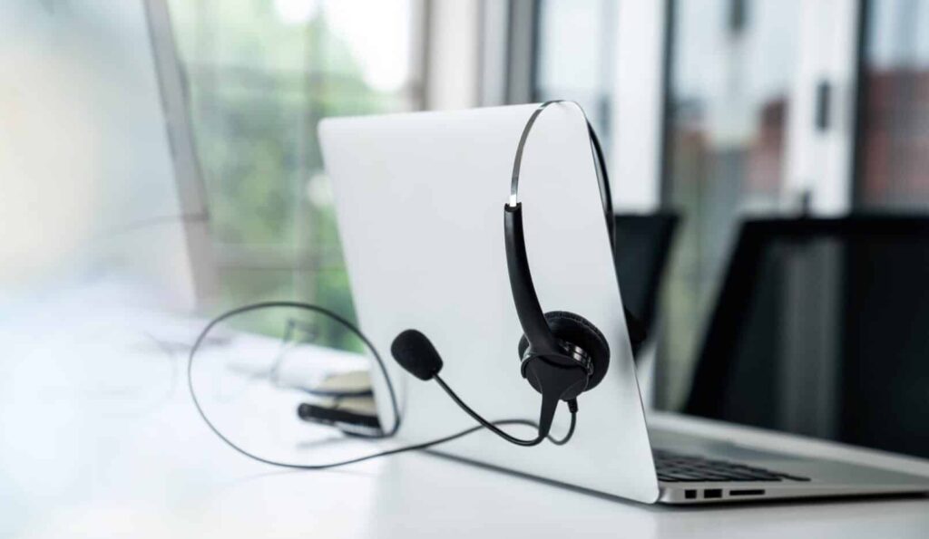 Headset and customer support equipment at call center ready for actively service . Corporate business help desk and telephone assistance concept .