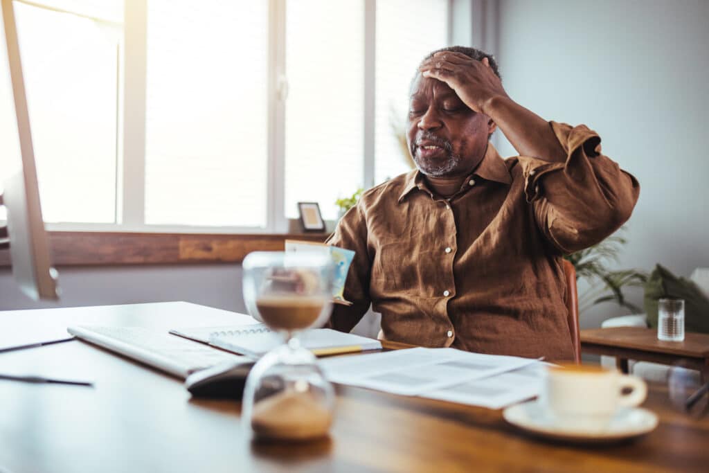 Old people, tax return and home banking. Angry senior man paying federal income taxes, doing family business plan. Elderly retired person and stress. Broken laptop pc, computer problems, technology