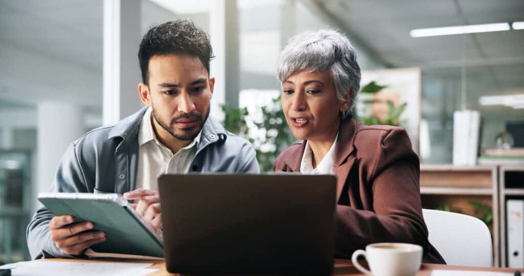 Creative people, tablet and laptop in office for planning, fact check and help with editor feedback. Staff, team and advice with tech for research, article comparison and information for publication.